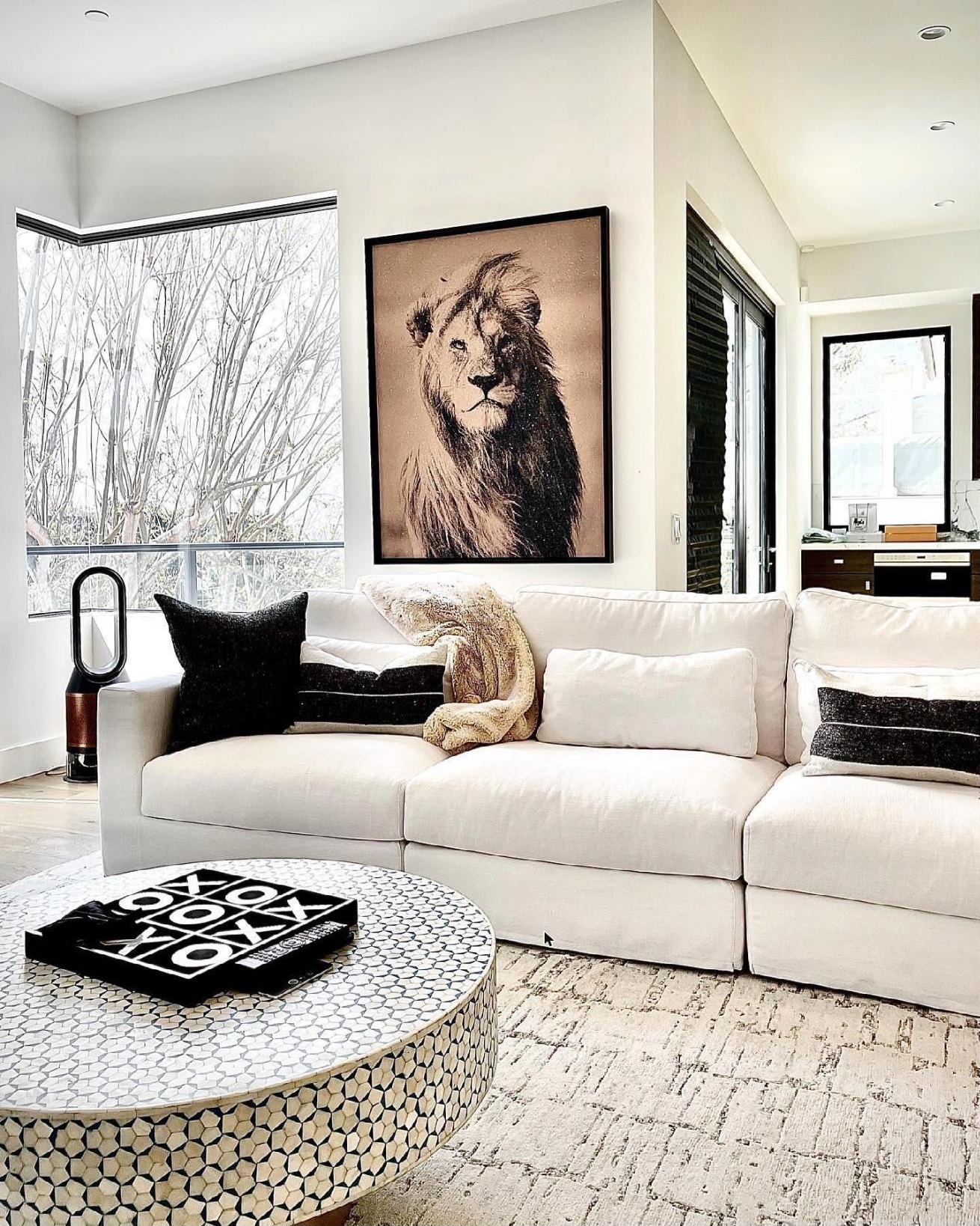 Diamond dust painting of a lion above a white sofa in a Newport Beach living room